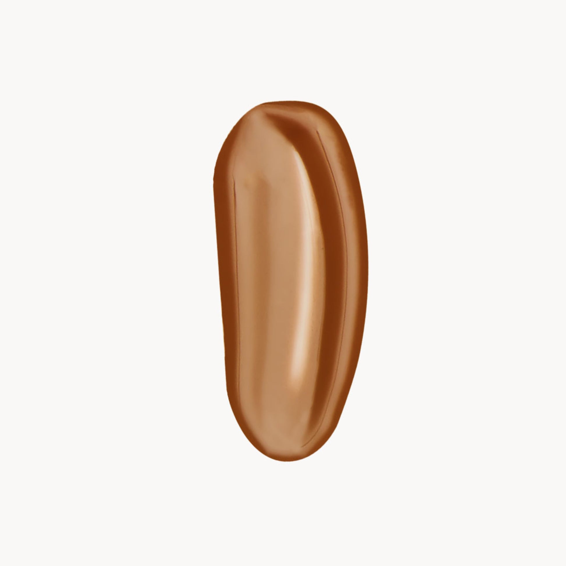 A wipe of warm-toned tan liquid foundation on a white background