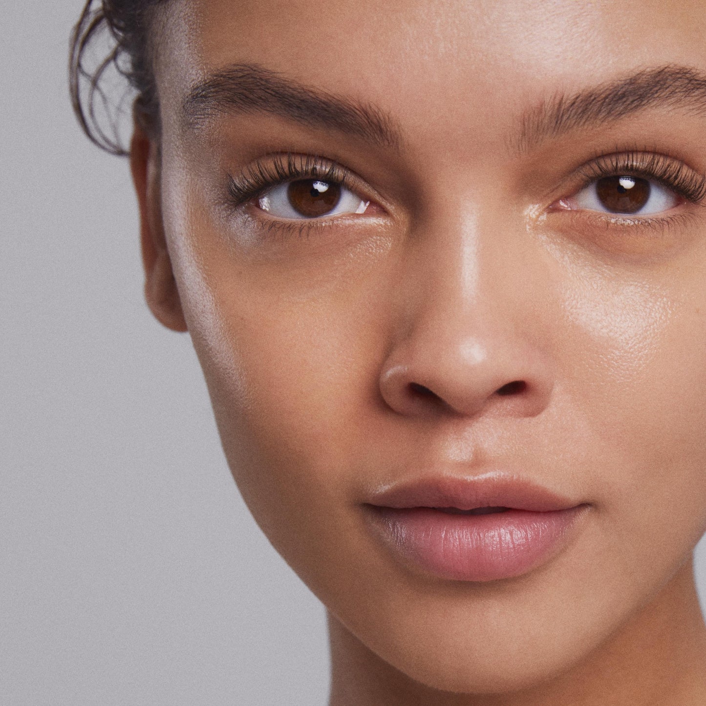 Close up of a person’s face with clear, glowing skin