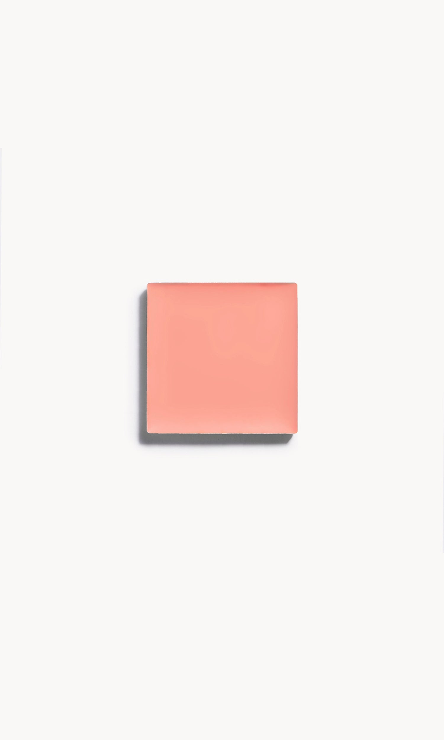 A square of soft peach cream blush on a white background
