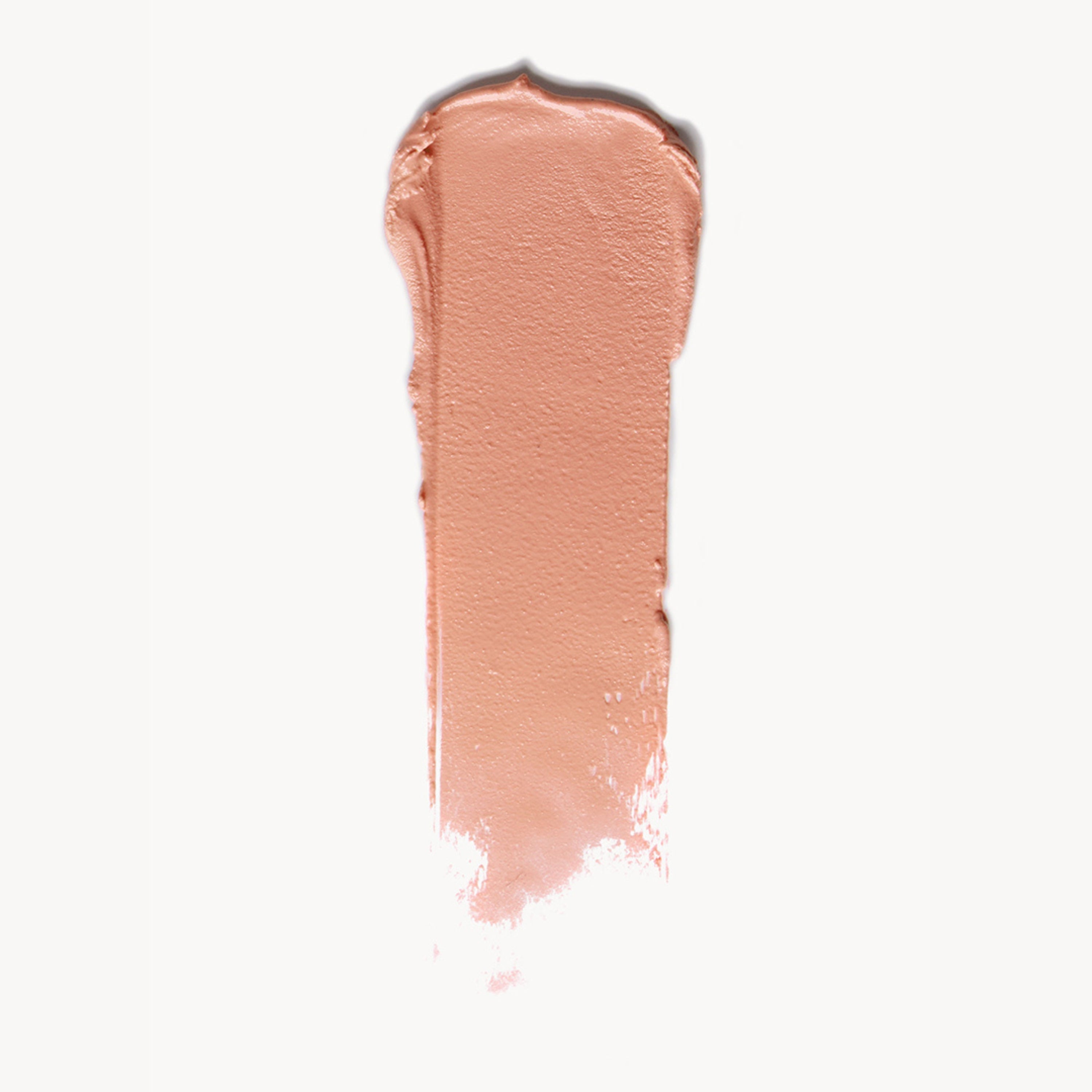 A wipe of soft peach cream blush on a white background