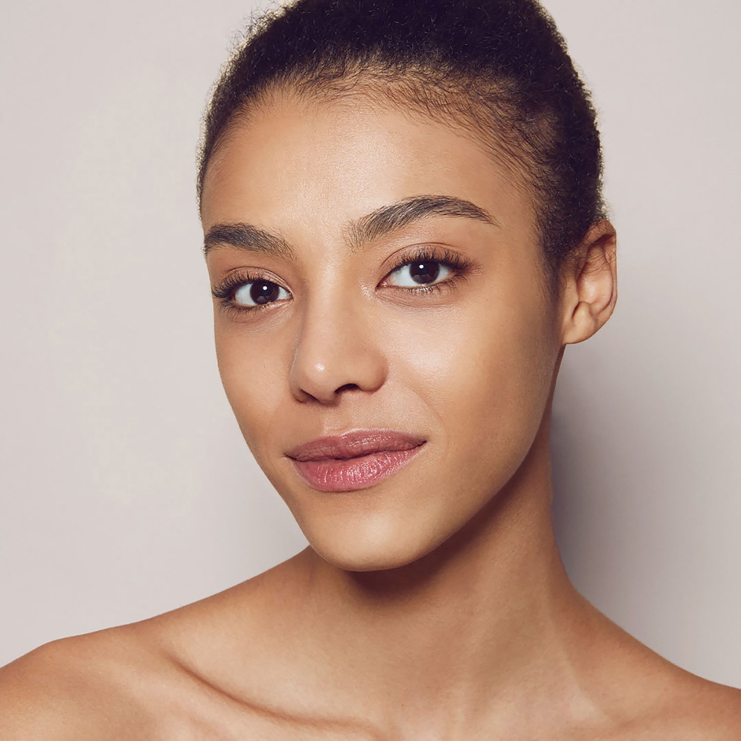 Close up of a person’s face with warm tan skin