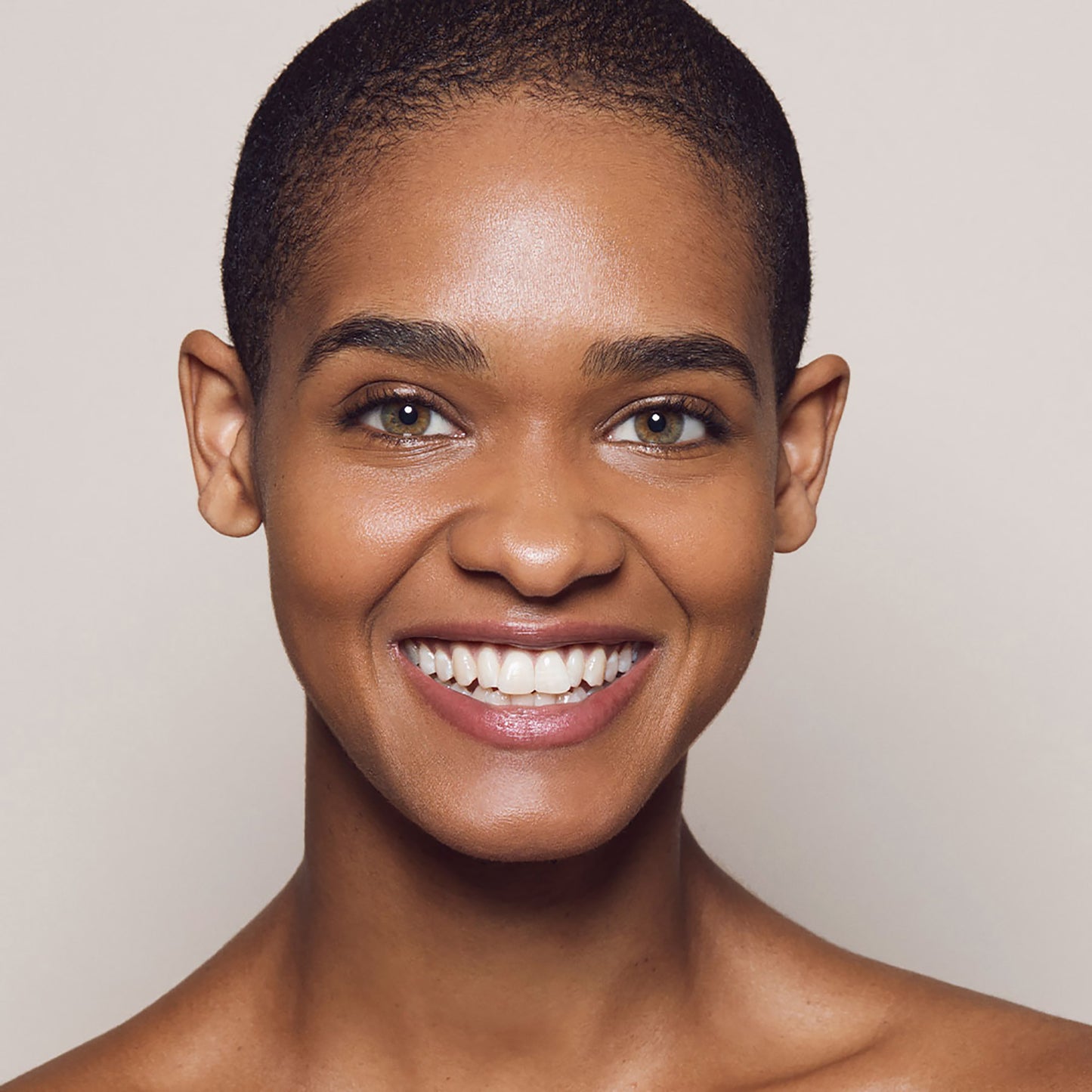 Close up of a person’s face with warm tan skin