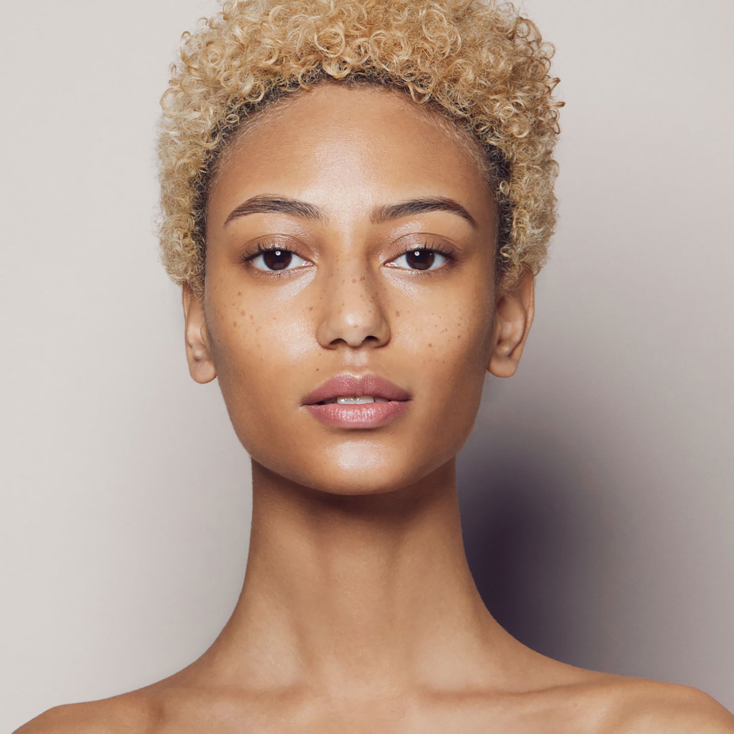Close up of a person’s face with warm tan skin
