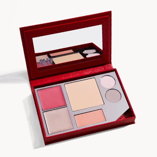 an open kit, showing the palette of cream blush, cream foundation, cream glow, lip tint, and two eye shadows, with a mirror on the inside of the lid