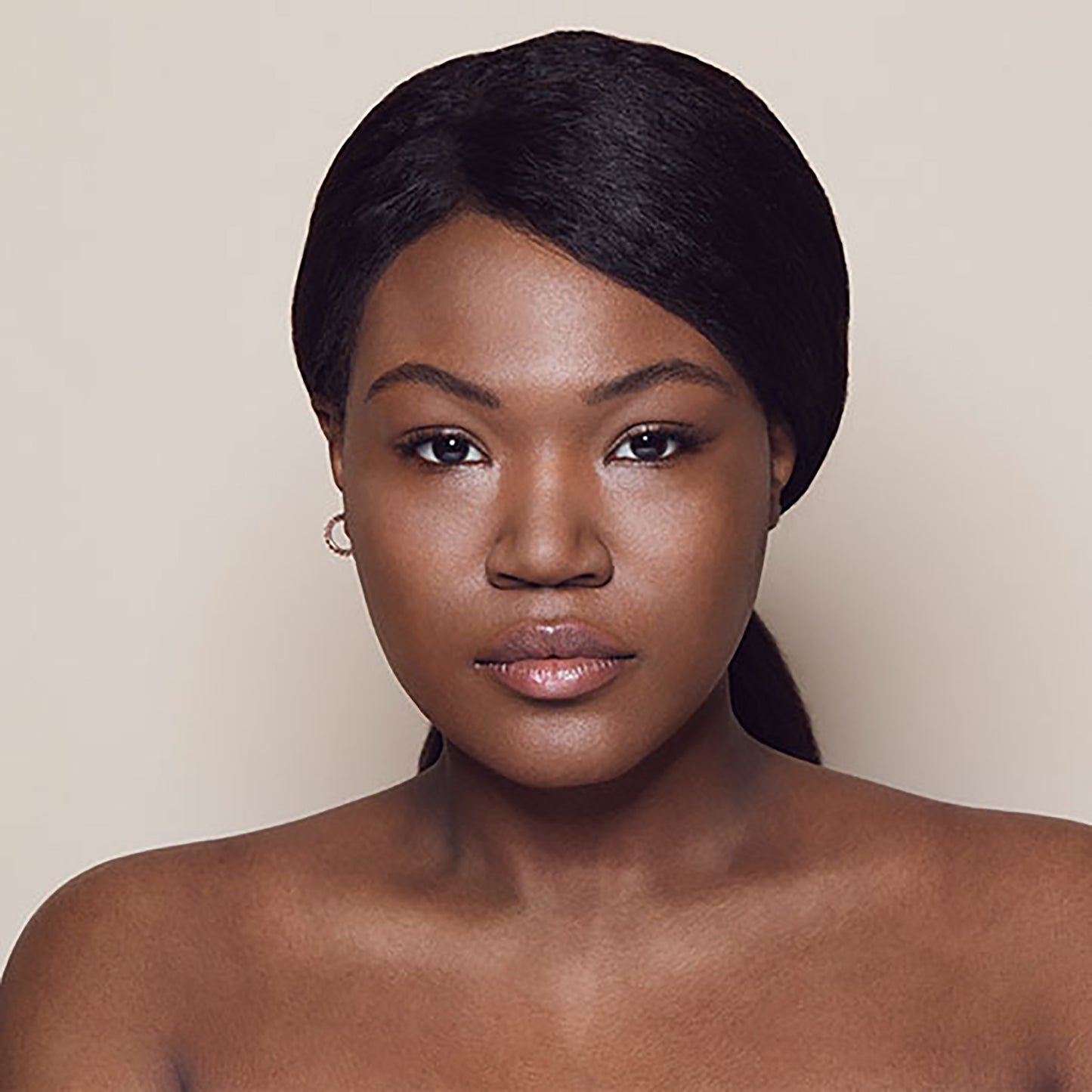 Close up of person’s face with deep, warm-toned skin