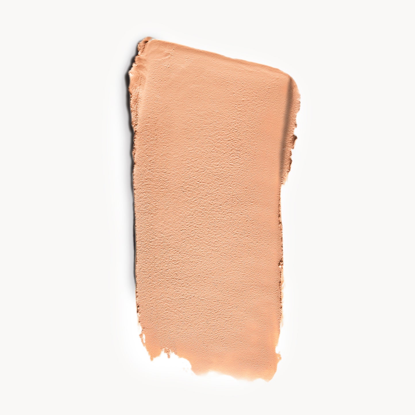 A wipe of light, cool-toned cream foundation on a white background