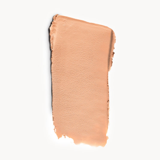 a wipe of light, cool-toned cream foundation on a white background