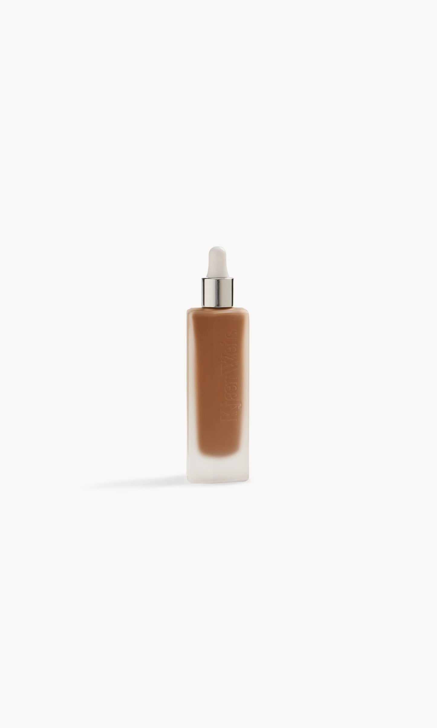 Frosted glass bottle with foundation inside and a white and silver pipette top