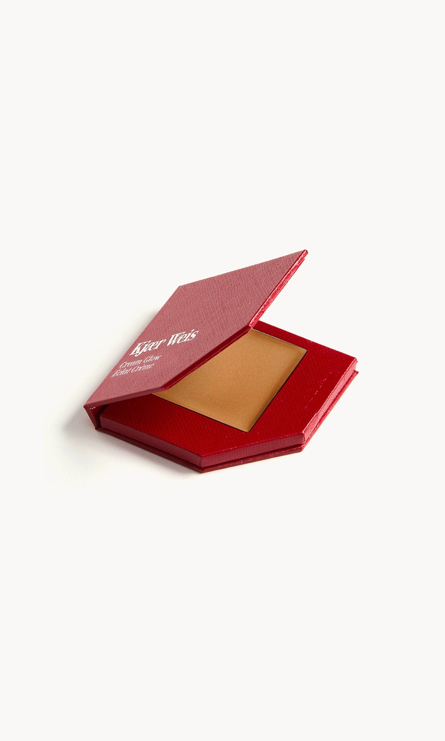 A red KW palette with the lid open to show the cream glow