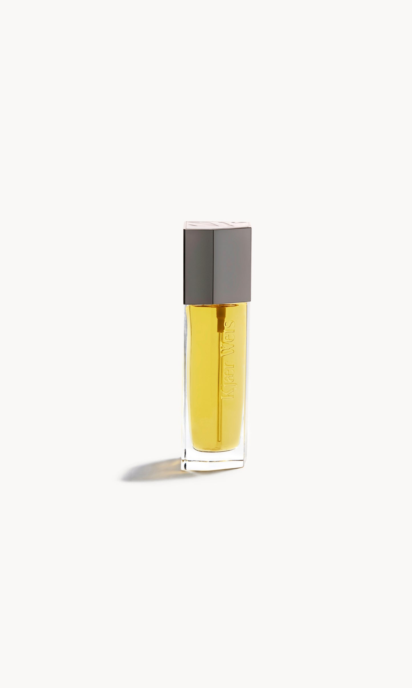 Kjaer Weis body oil in glass bottle with silver cap