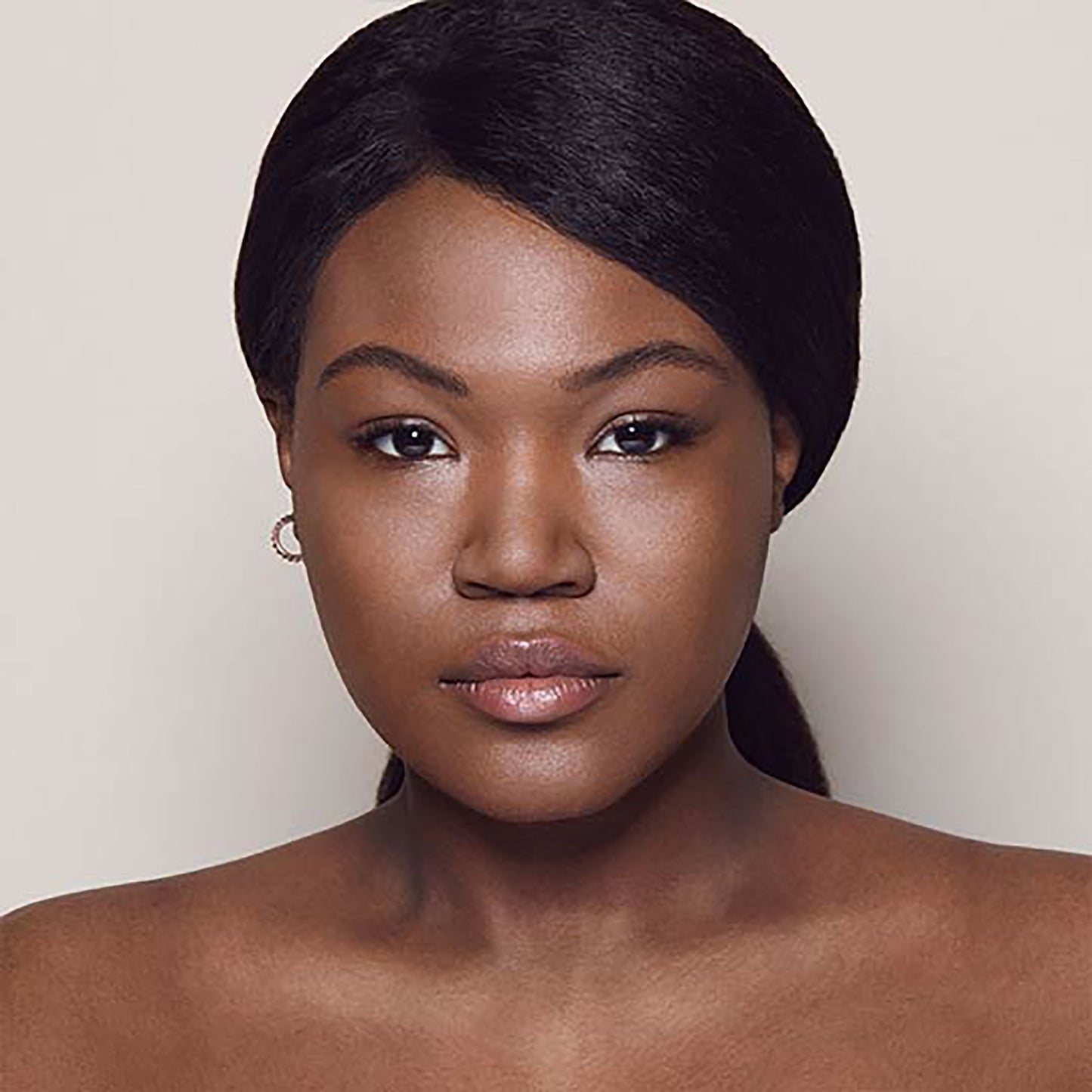 A photo of a person’s face with deep skin tone