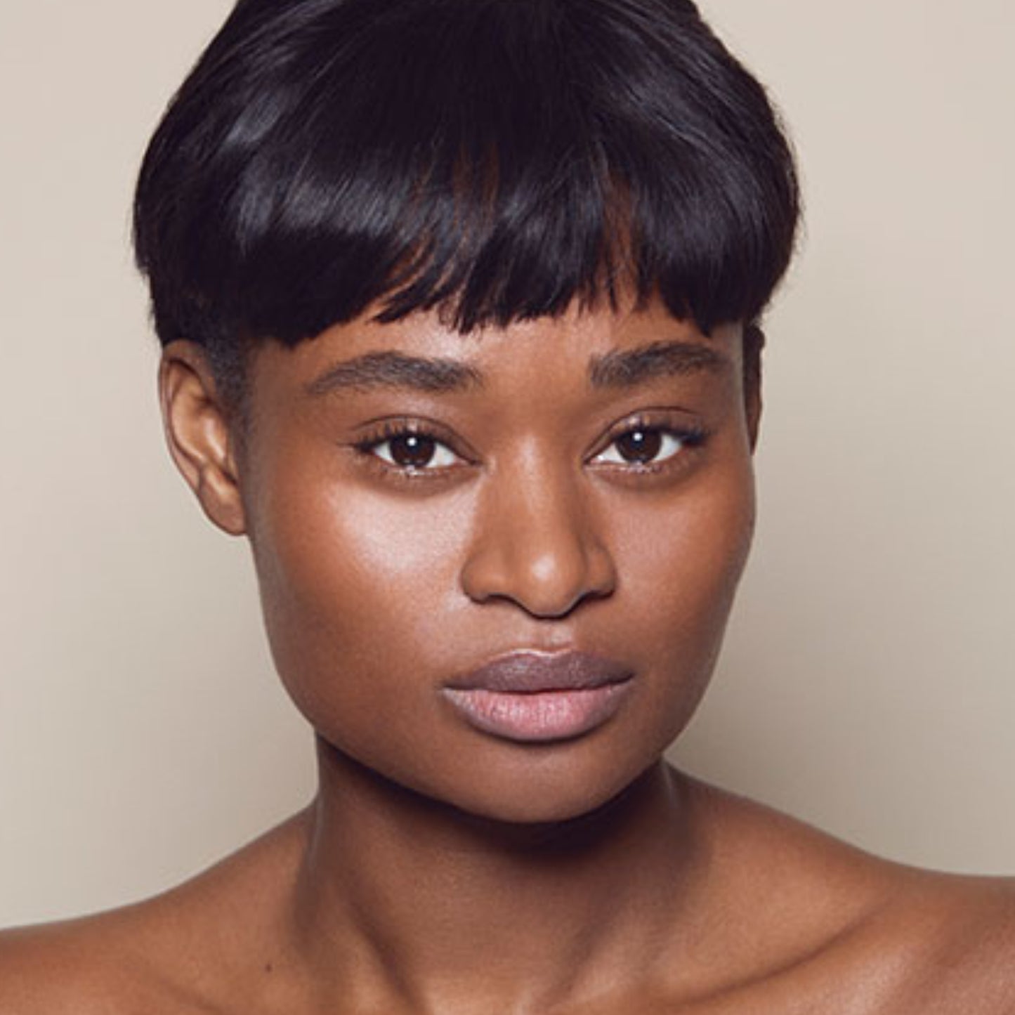 Photo of a person’s face with deep, neutral-toned skin