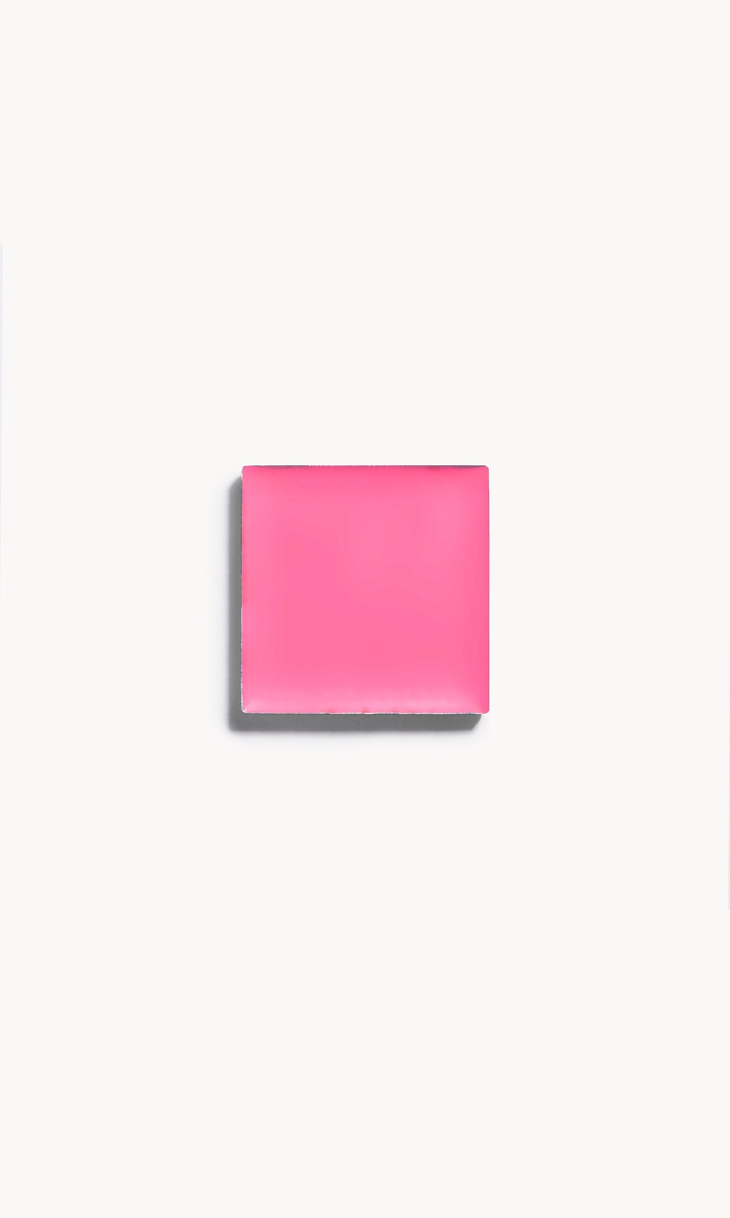 a square of vibrant pink cream blush on a white background