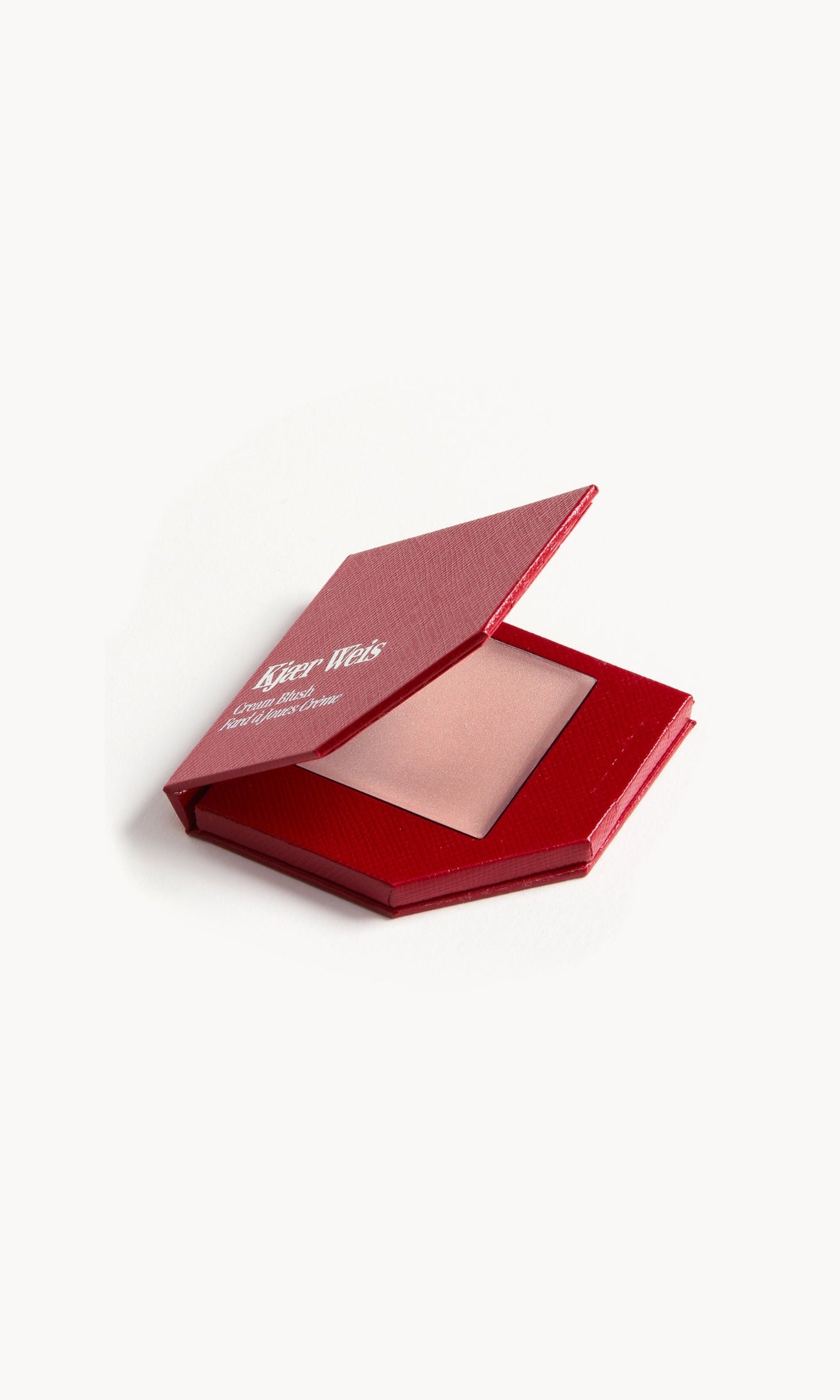 A red KW palette with the lid open to show the cream blush