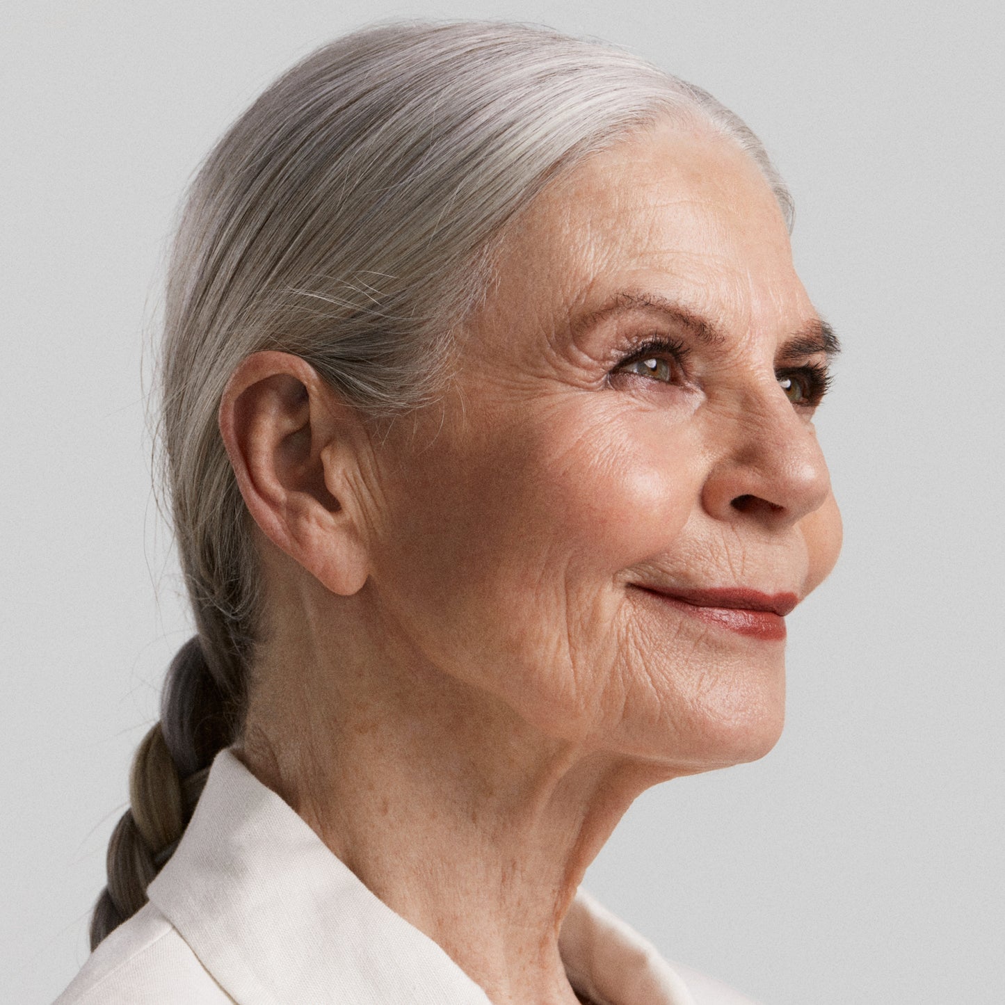 Close up of a person’s face with a fair skin tone wearing cream blush