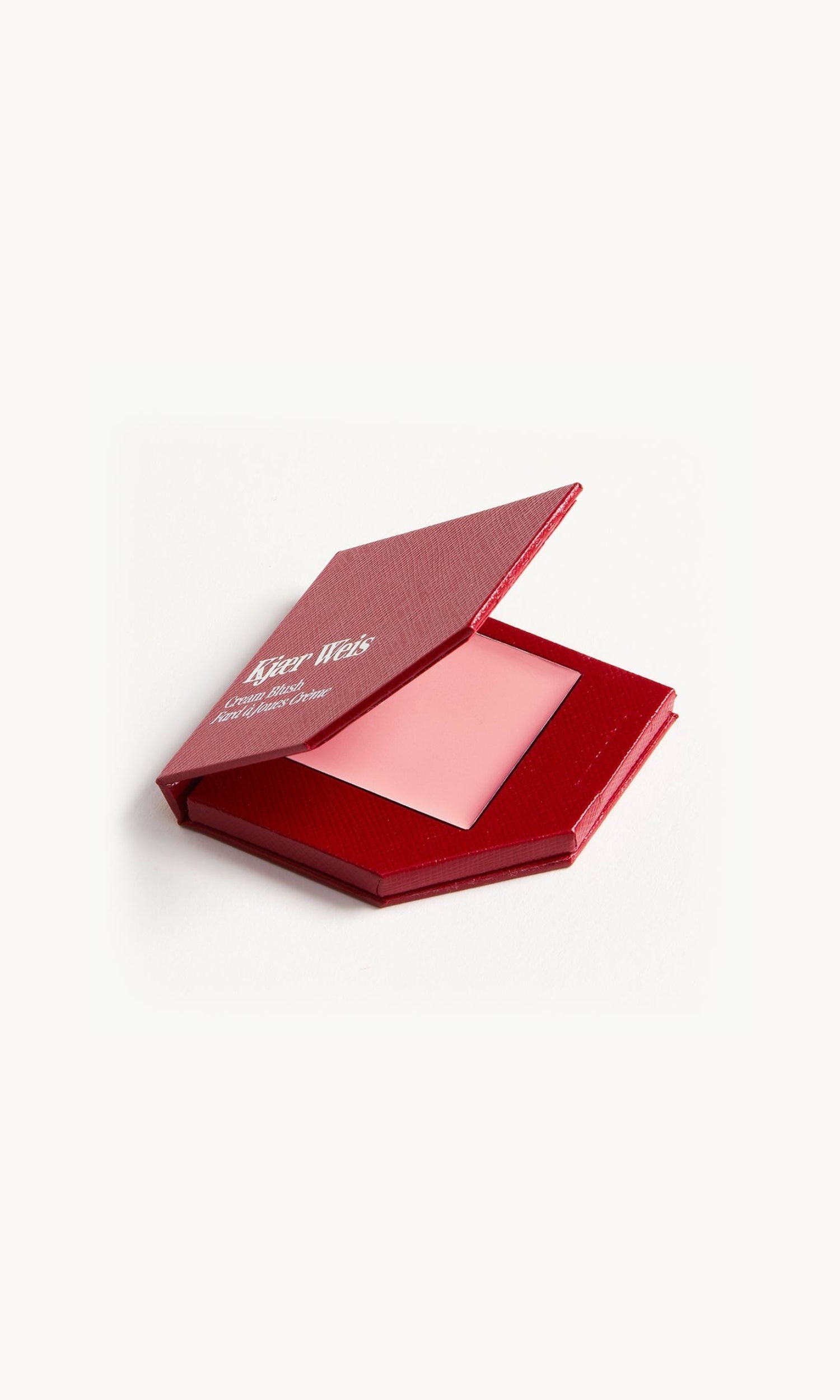 A red KW palette with the lid open to show the cream blush