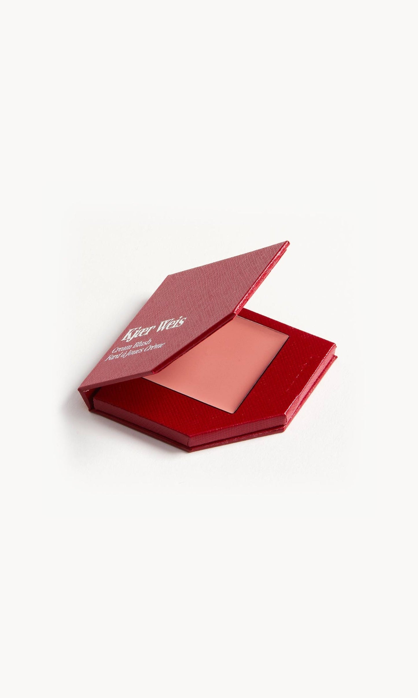 A red KW palette with the lid open to show the cream blush