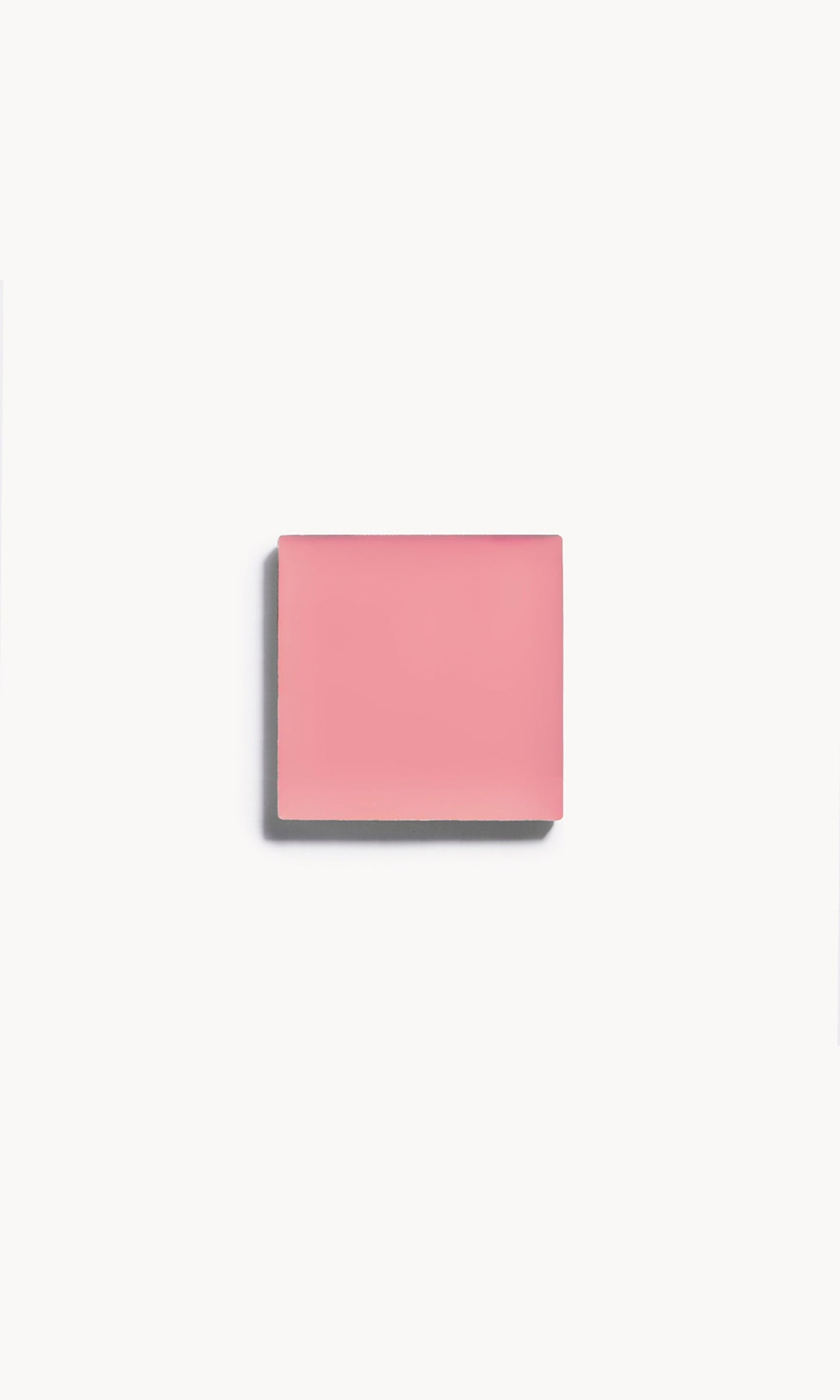 A square of cool pink cream blush on a white background