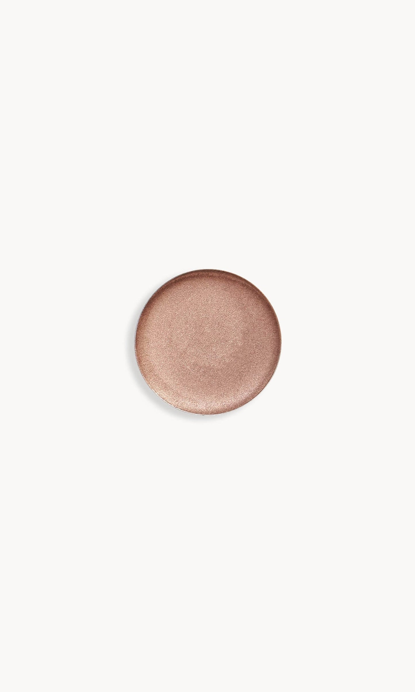 Circle of iridescent light mocha-coloured cream eye shadow on white background