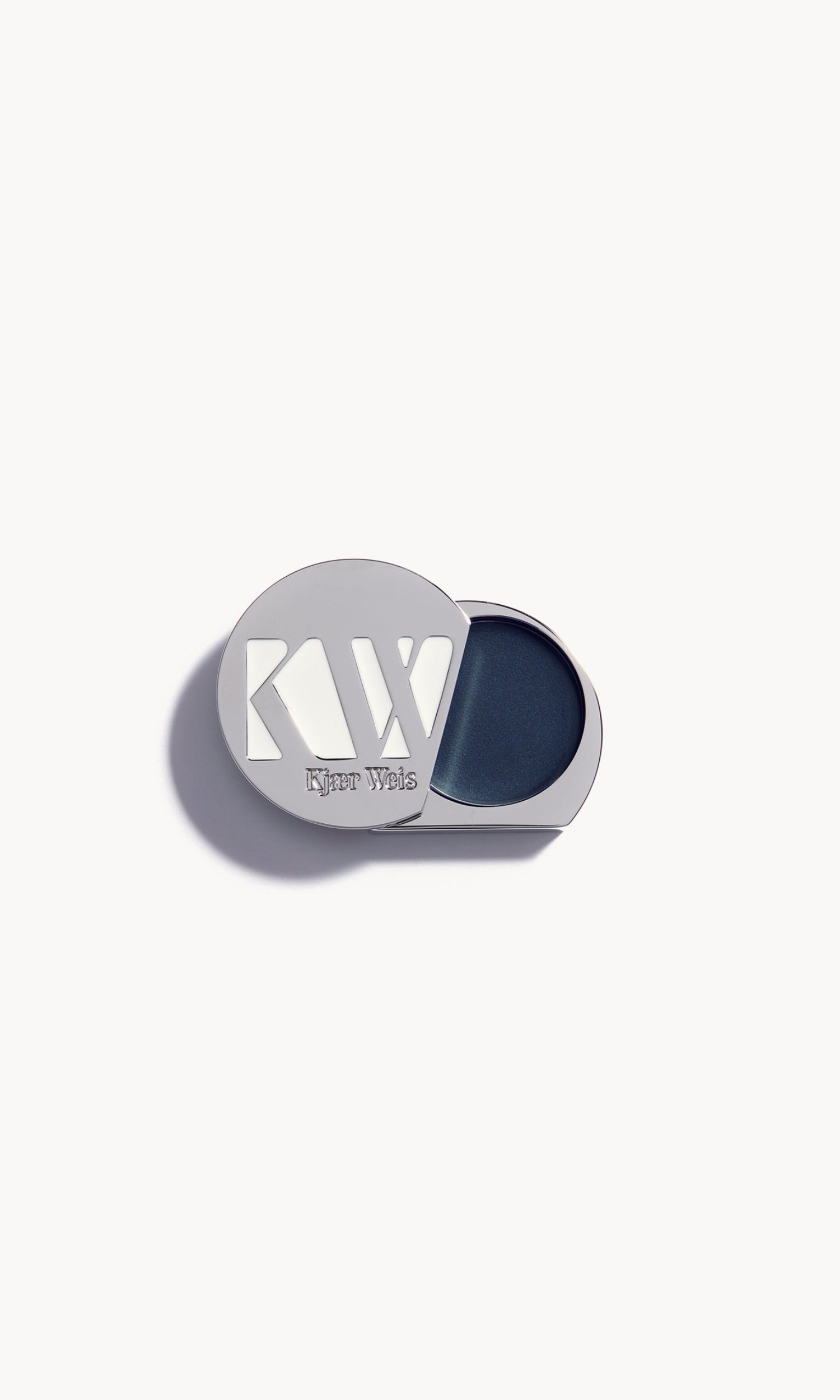 solid metal palette with lid slid open to show cream eye shadow