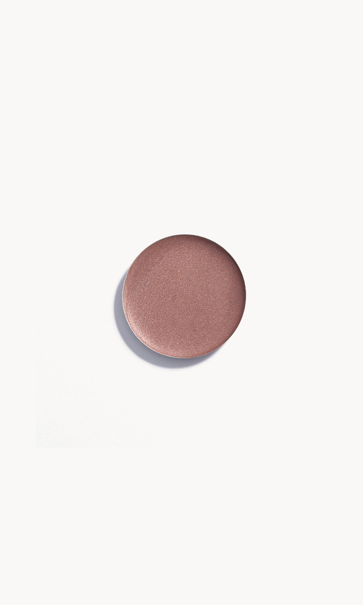 Circle of medium taupe cream eye shadow on white background