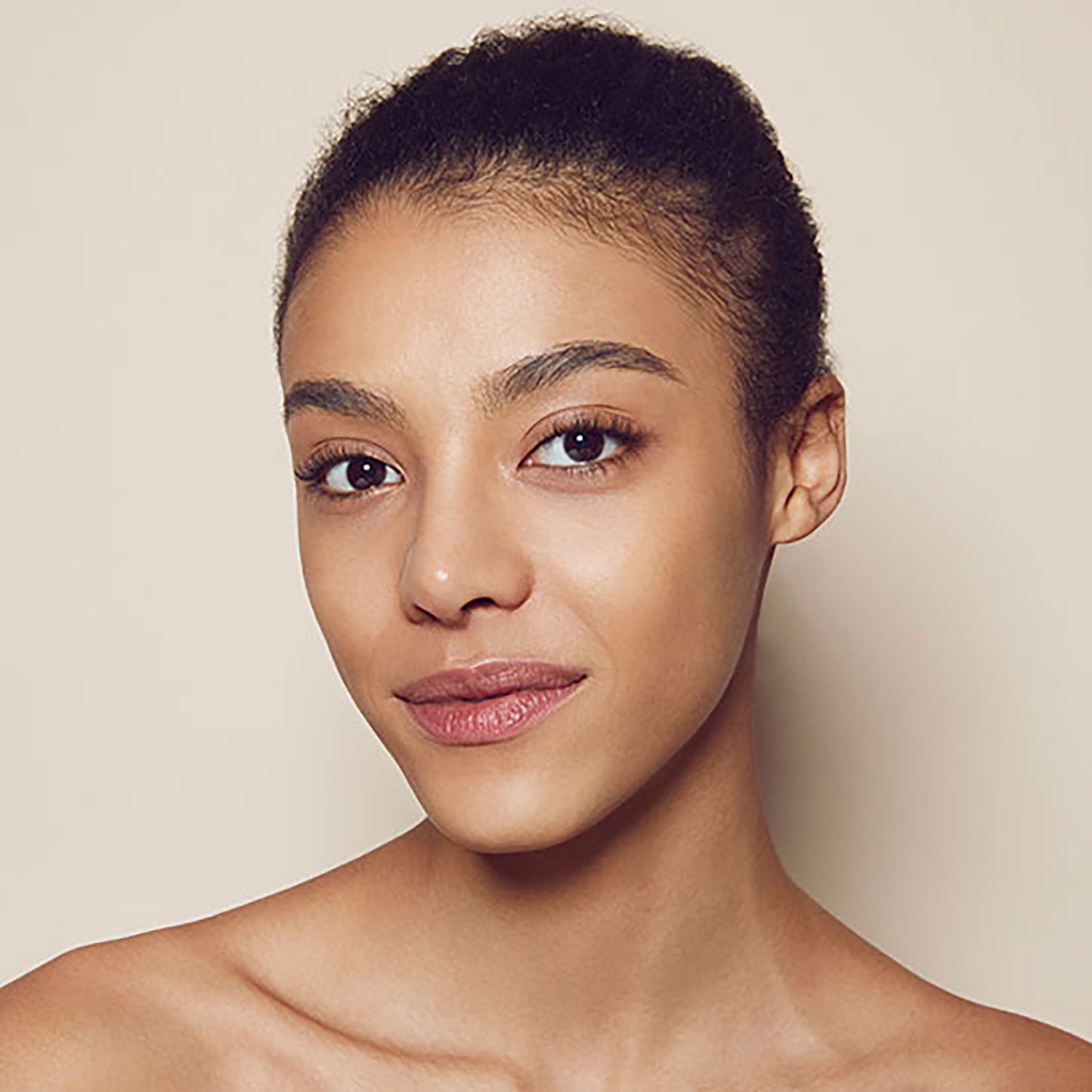 Close up of person’s face with tan, warm-toned skin