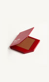 Red KW palette with lid open to show cream foundation