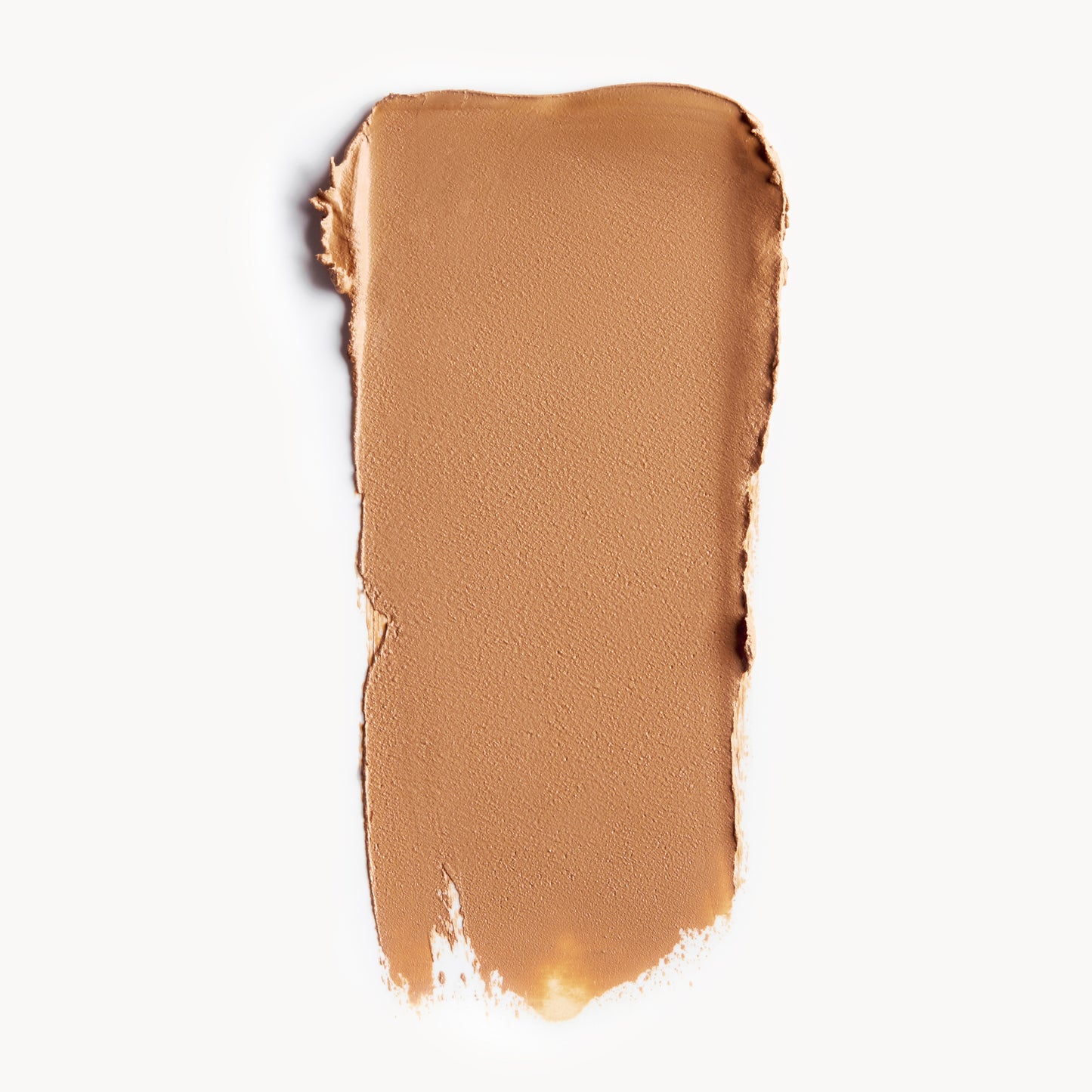 A wipe of medium, warm-toned cream foundation on a white background
