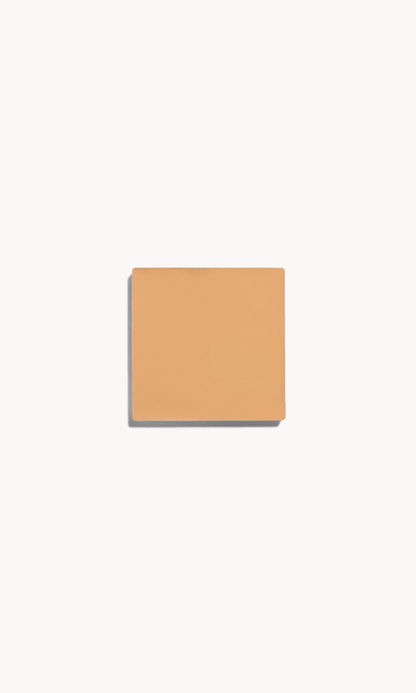 Square of medium cool-toned cream foundation on a white background