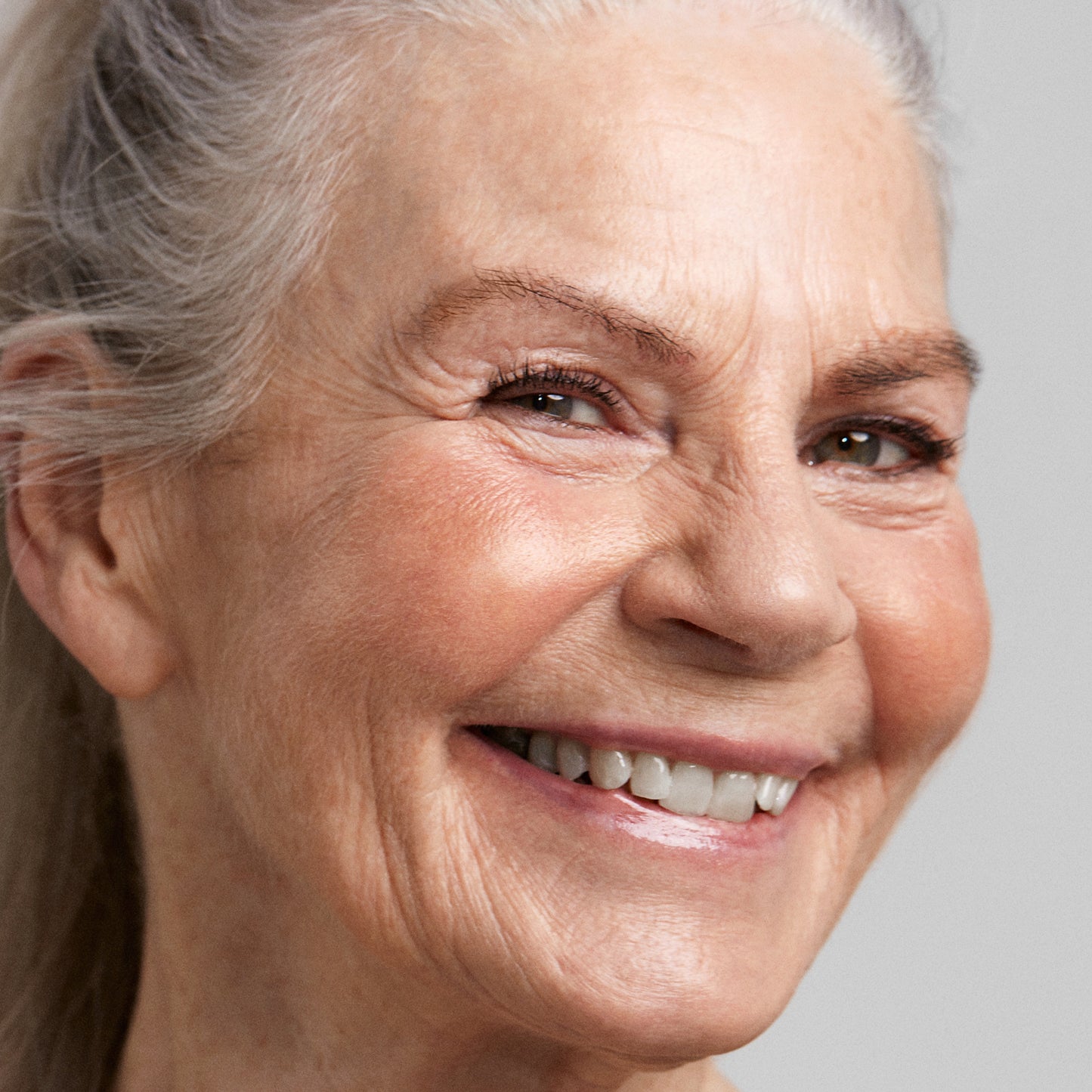 Close up of a person’s face with a fair skin tone wearing cream bronzer 