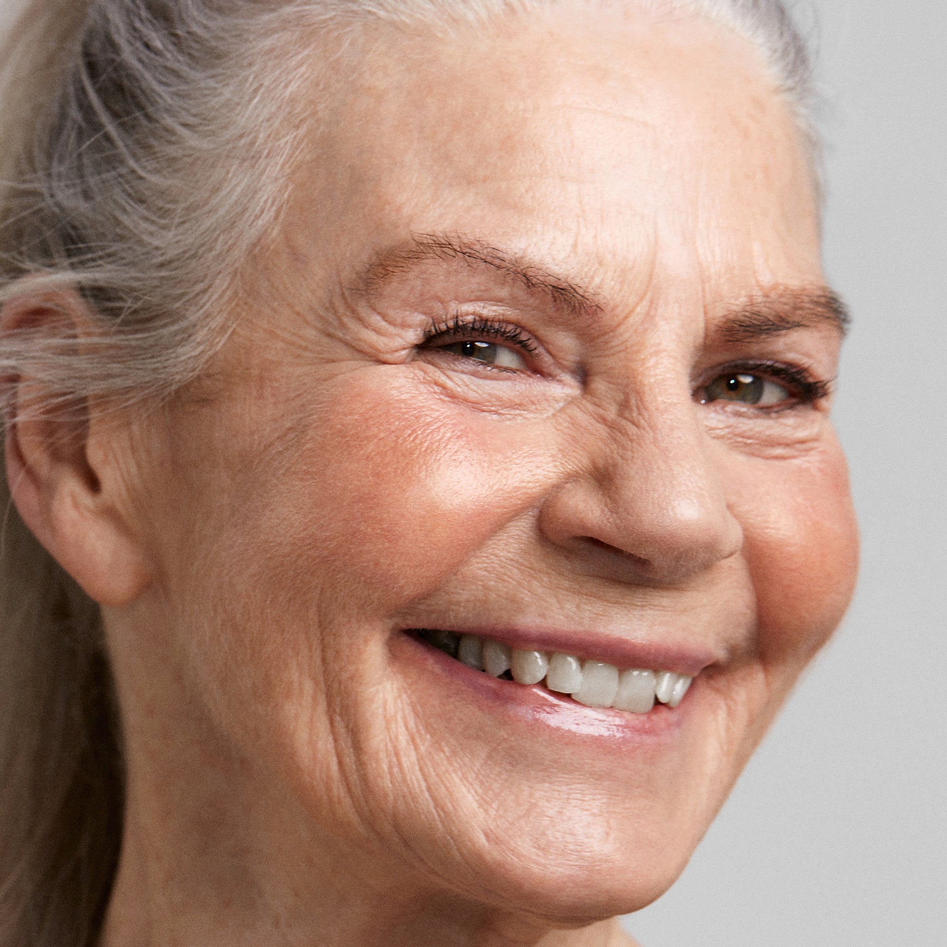Close up of a person’s face with a fair skin tone wearing cream bronzer
