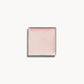 A square of cool silvery-pearl cream highlighter on a white background