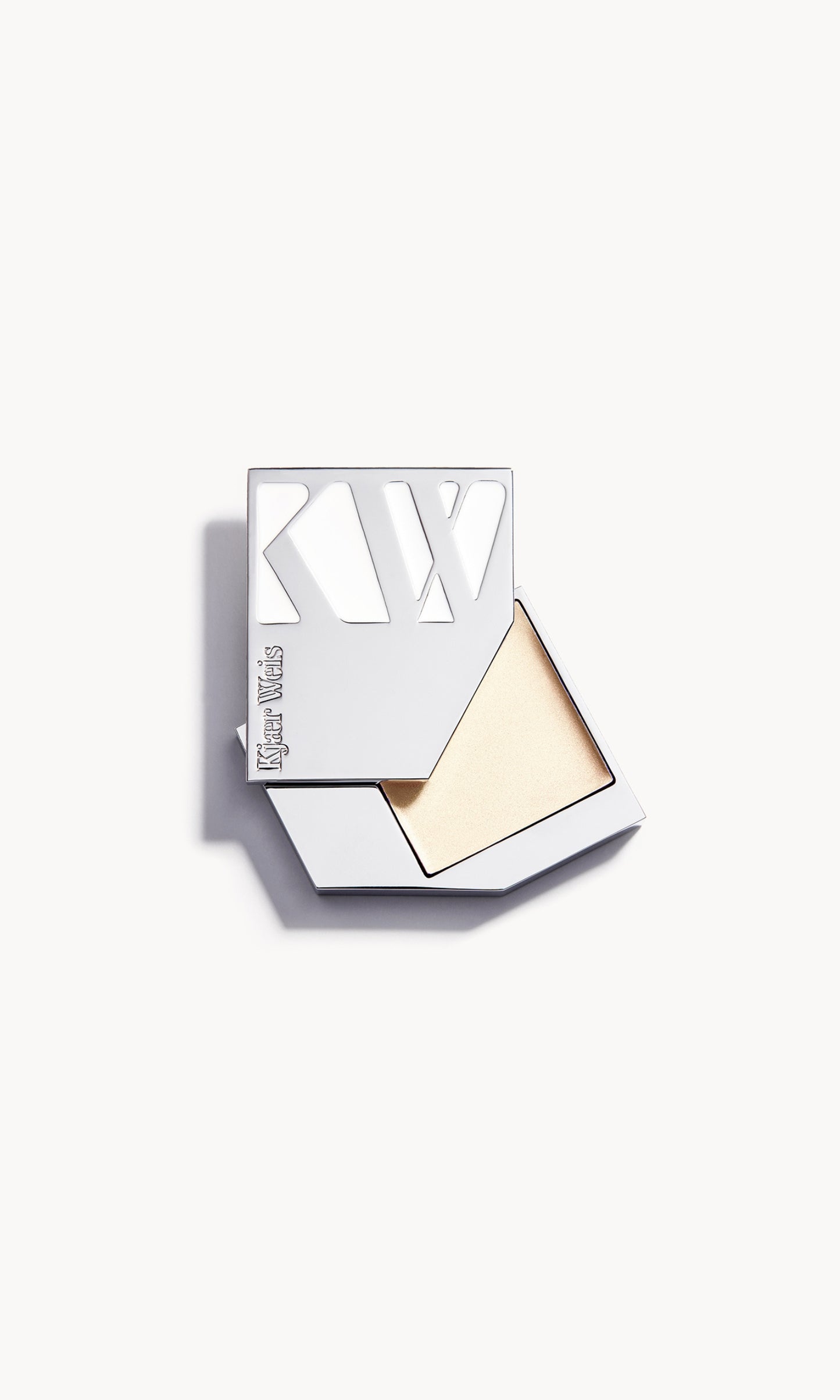 A solid metal KW palette with the lid slid open to show the cream highlighter