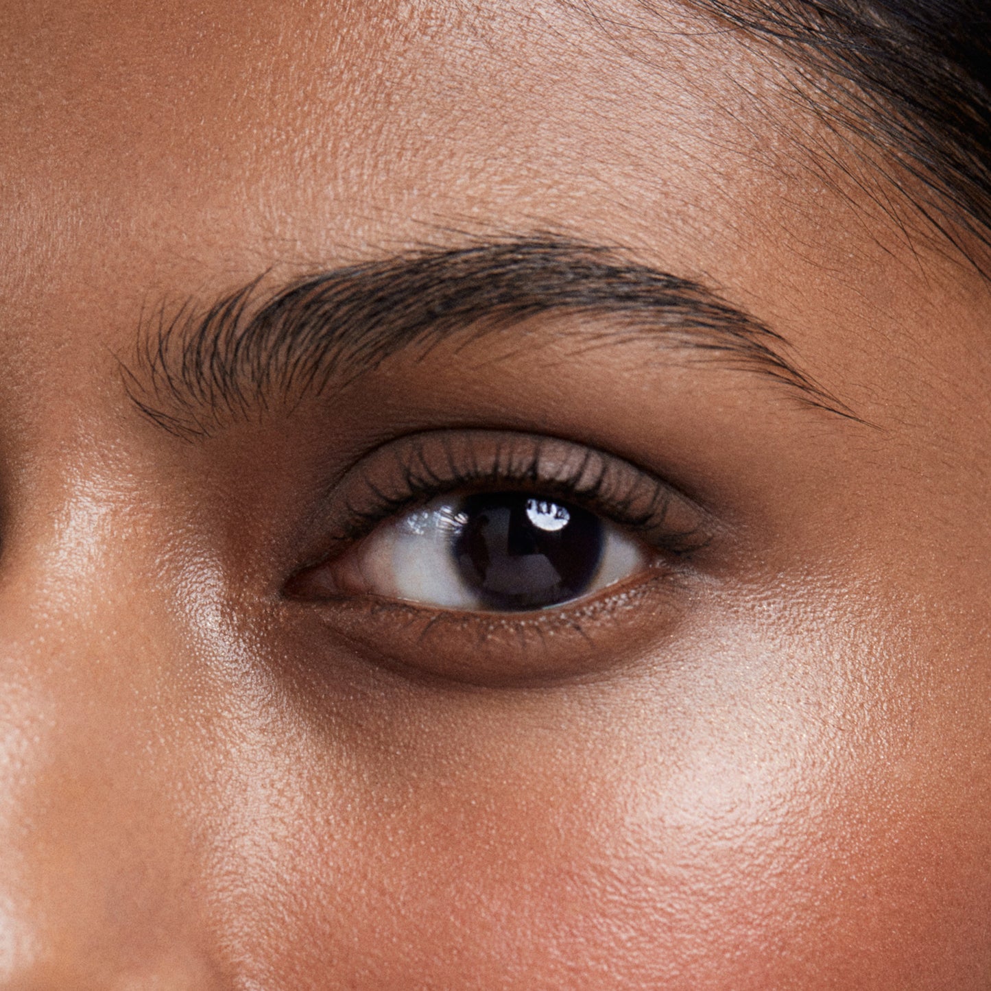 Close up of a person’s eye wearing greyish brown eye shadow