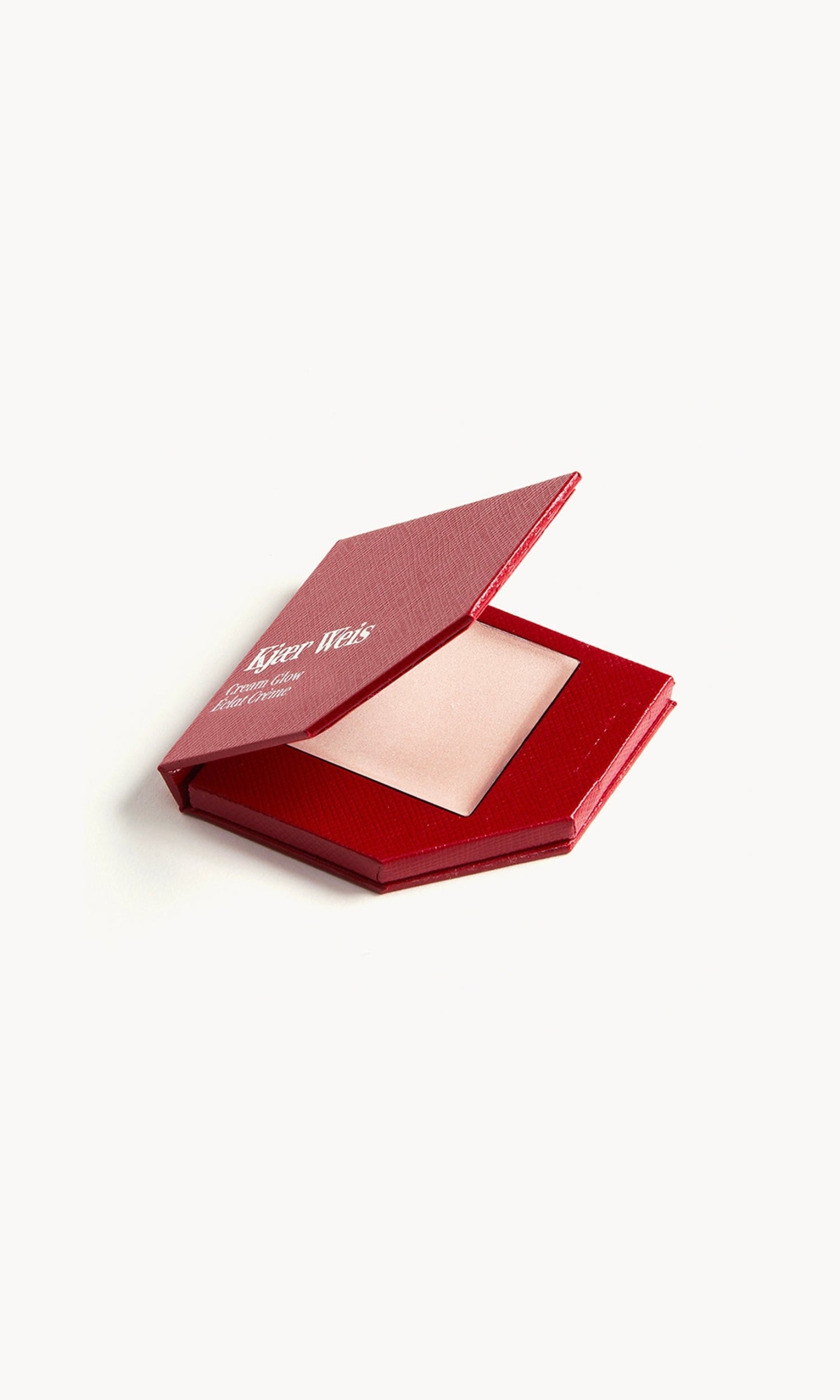 A red KW palette with the lid open to show the cream glow