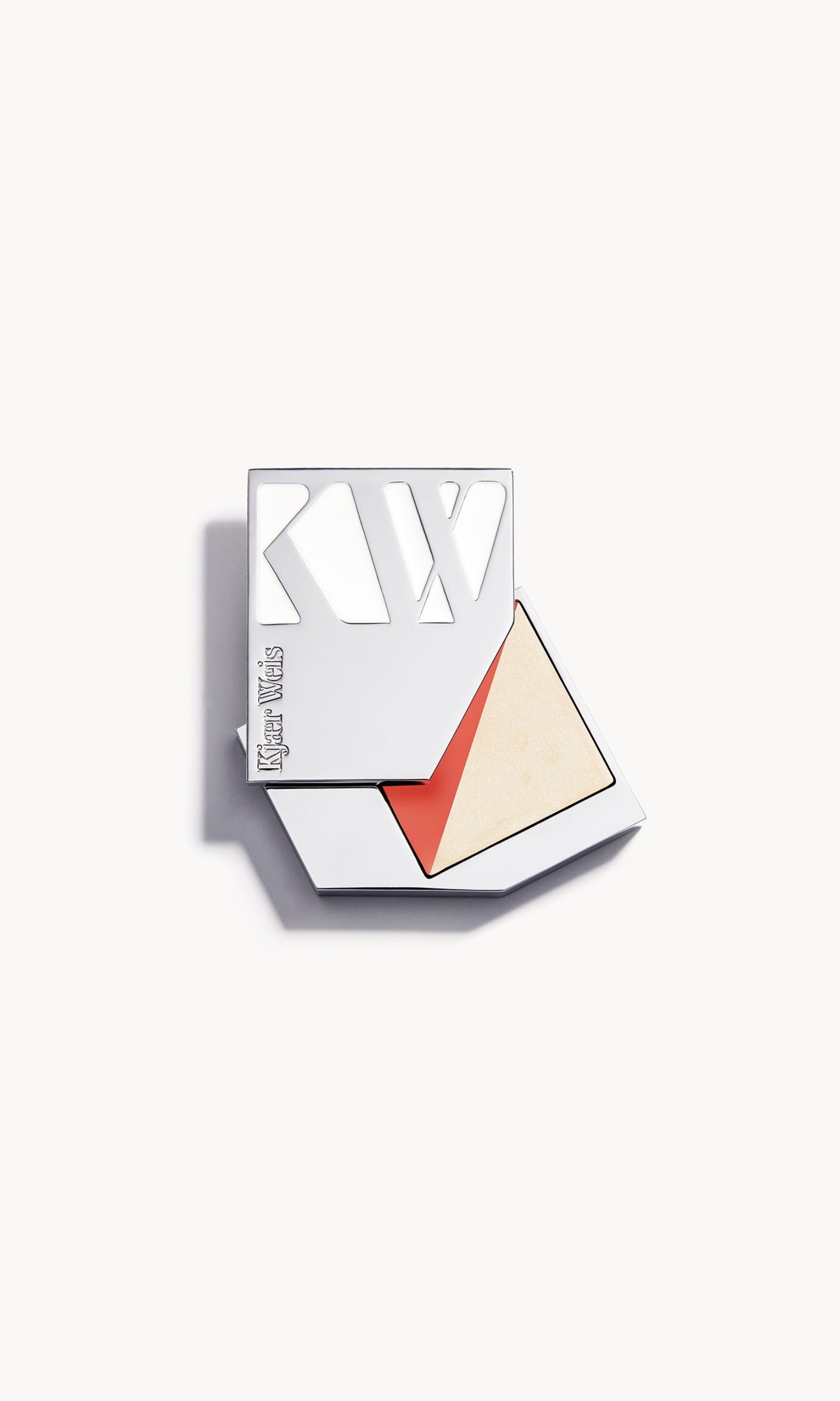 Silver metal KW palette open to show a rectangle palette split diagonally in half, with a warm coral blush on one side and a golden cream highlighter on the other