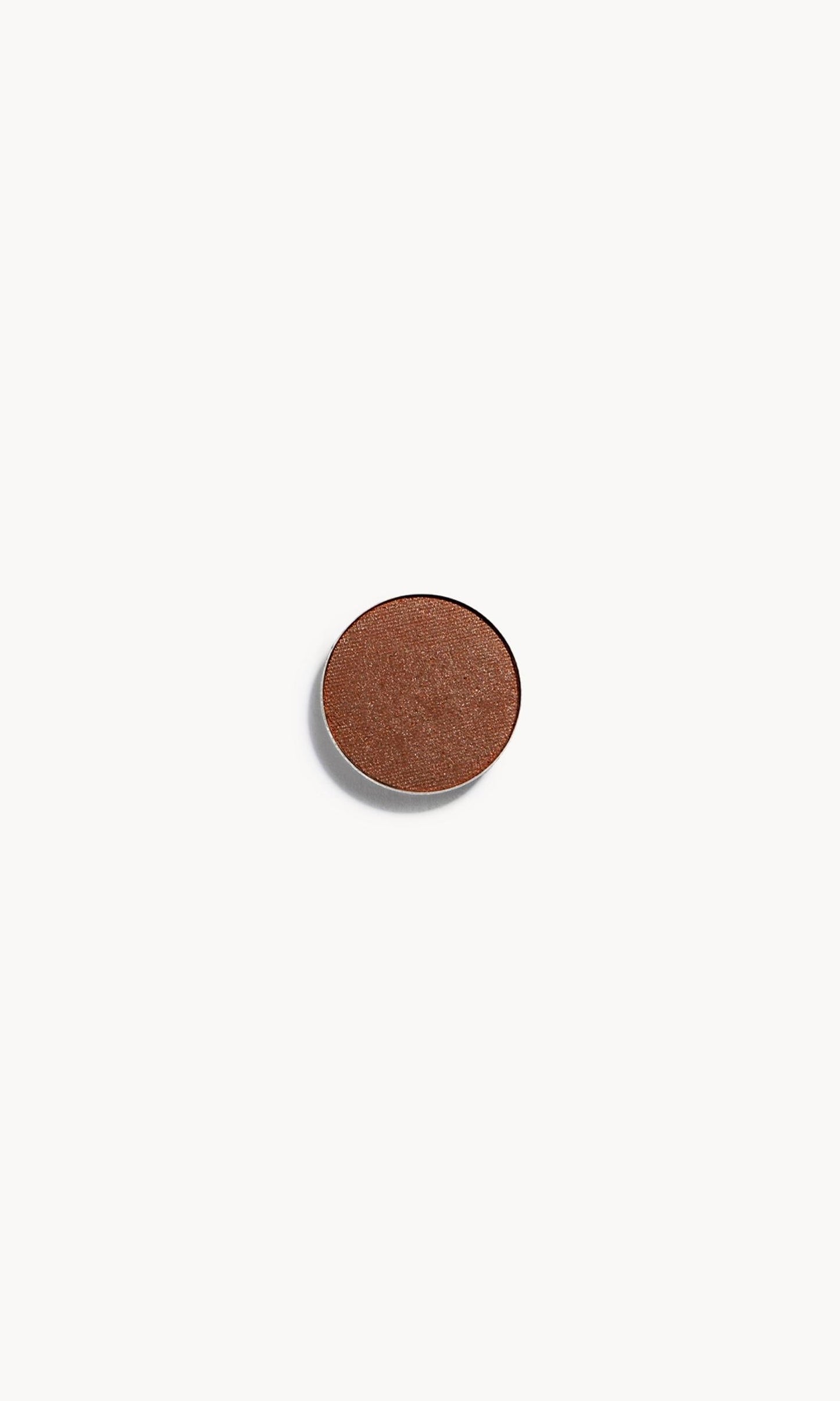 A circle of warm brown eye shadow on a white background