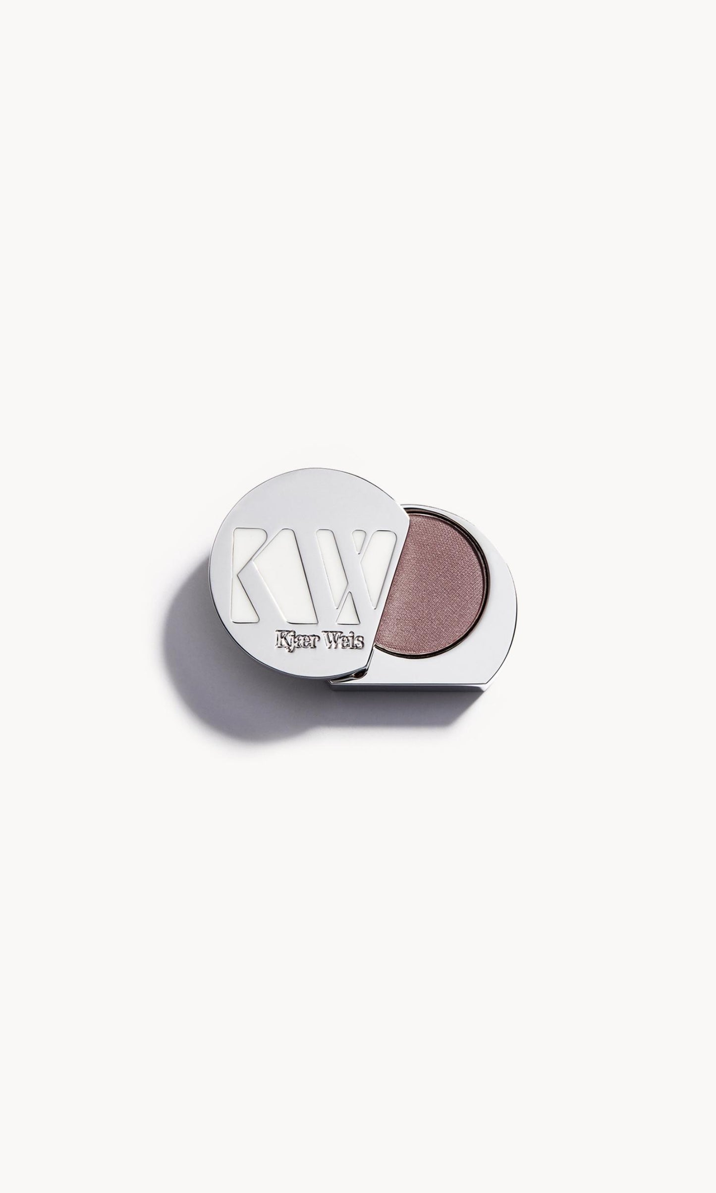 Solid metal KW palette with lid open to show taupe eye shadow inside