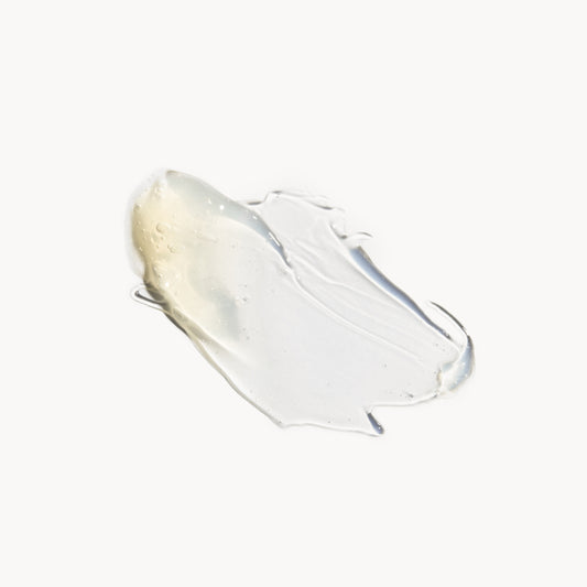a deposit of cleanser on a white background. the product is gold-coloured, turning clear when it is thinned out.