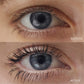 A close up of a person’s eyes showing them before and after applying Im-Possible mascara