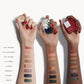 Three arms of three different skin tones all with a swatch of each cream eyeshadow shade