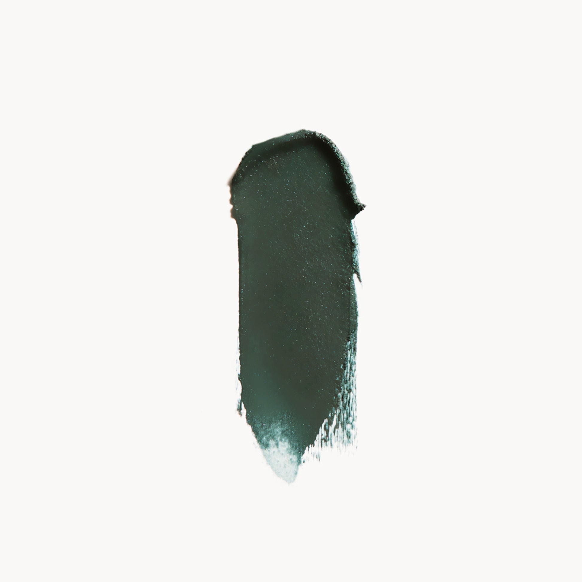 A wipe of dark green eye shadow on a white background