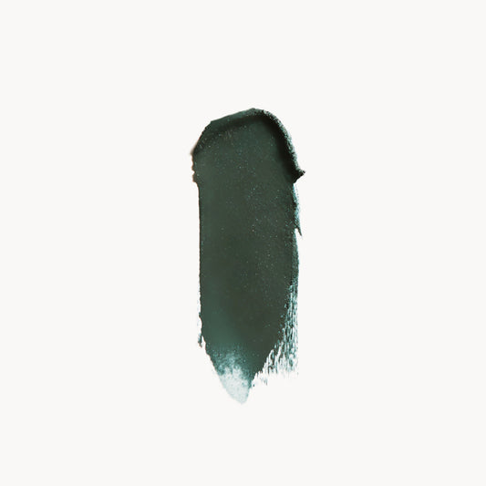 a wipe of dark green eye shadow on a white background