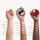 Three arms of three different skin tones all with a swatch of cream foundation from darkest to lightest shade. Transparent is the third lightest shade on the deepest skin tone. 