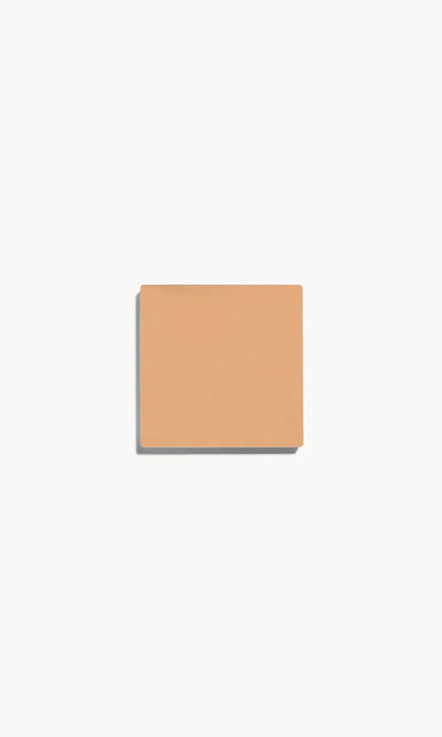 Square of medium neutral-toned cream foundation on a white background