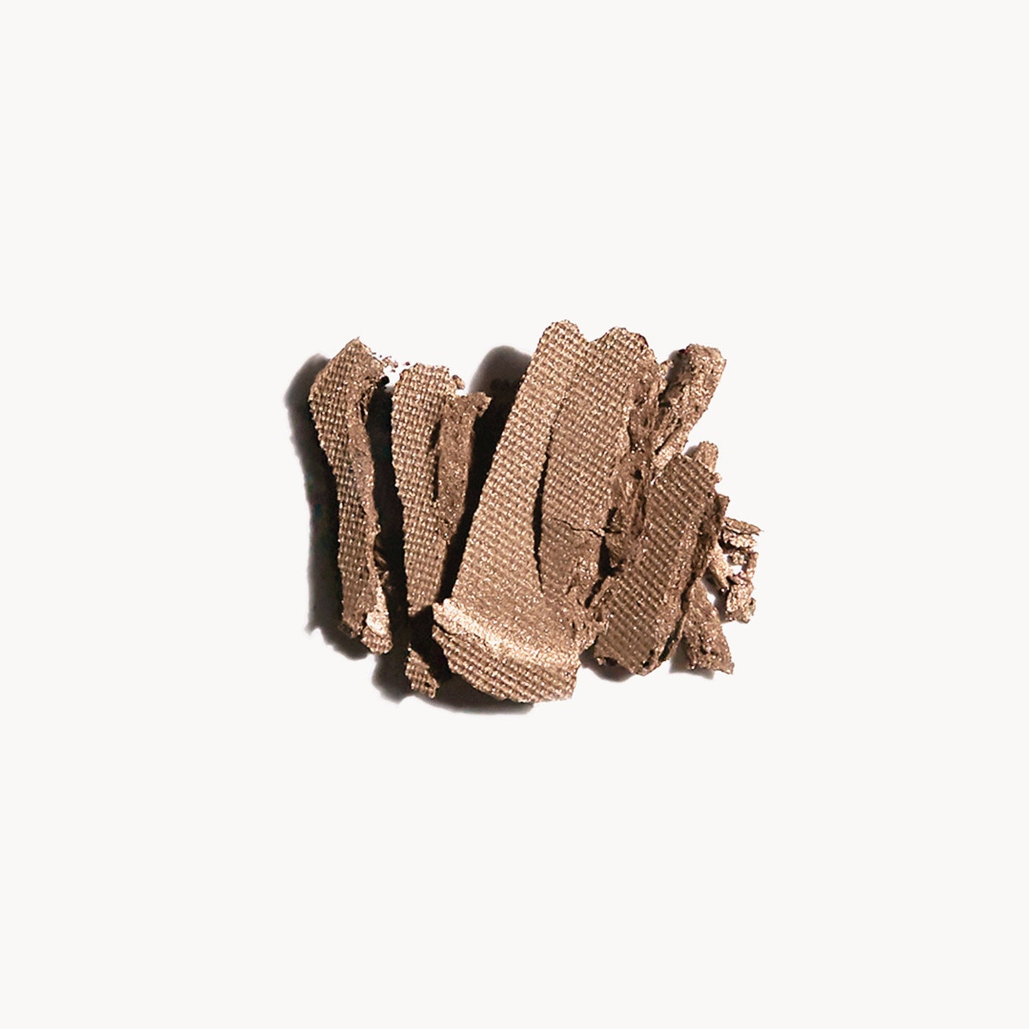 Crumbled up light mocha eye shadow on a white background