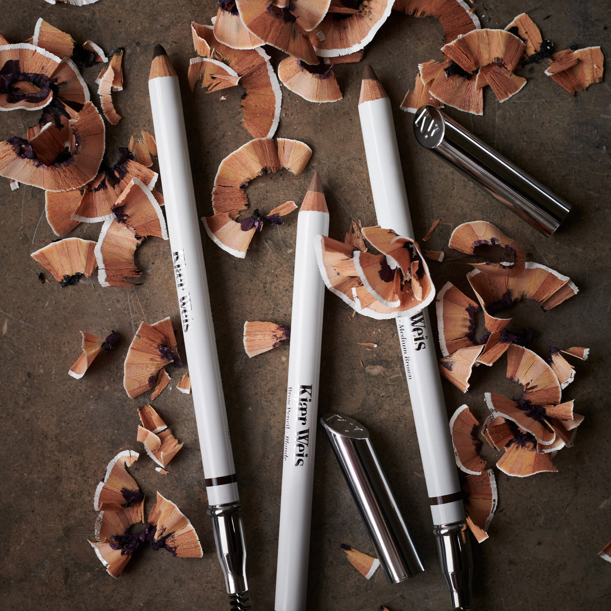 Kjaer Weis's brow pencils with pencil shavings, showcasing ability to be sharpened.