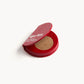 Red KW palette open to show the brown-gold eye shadow inside