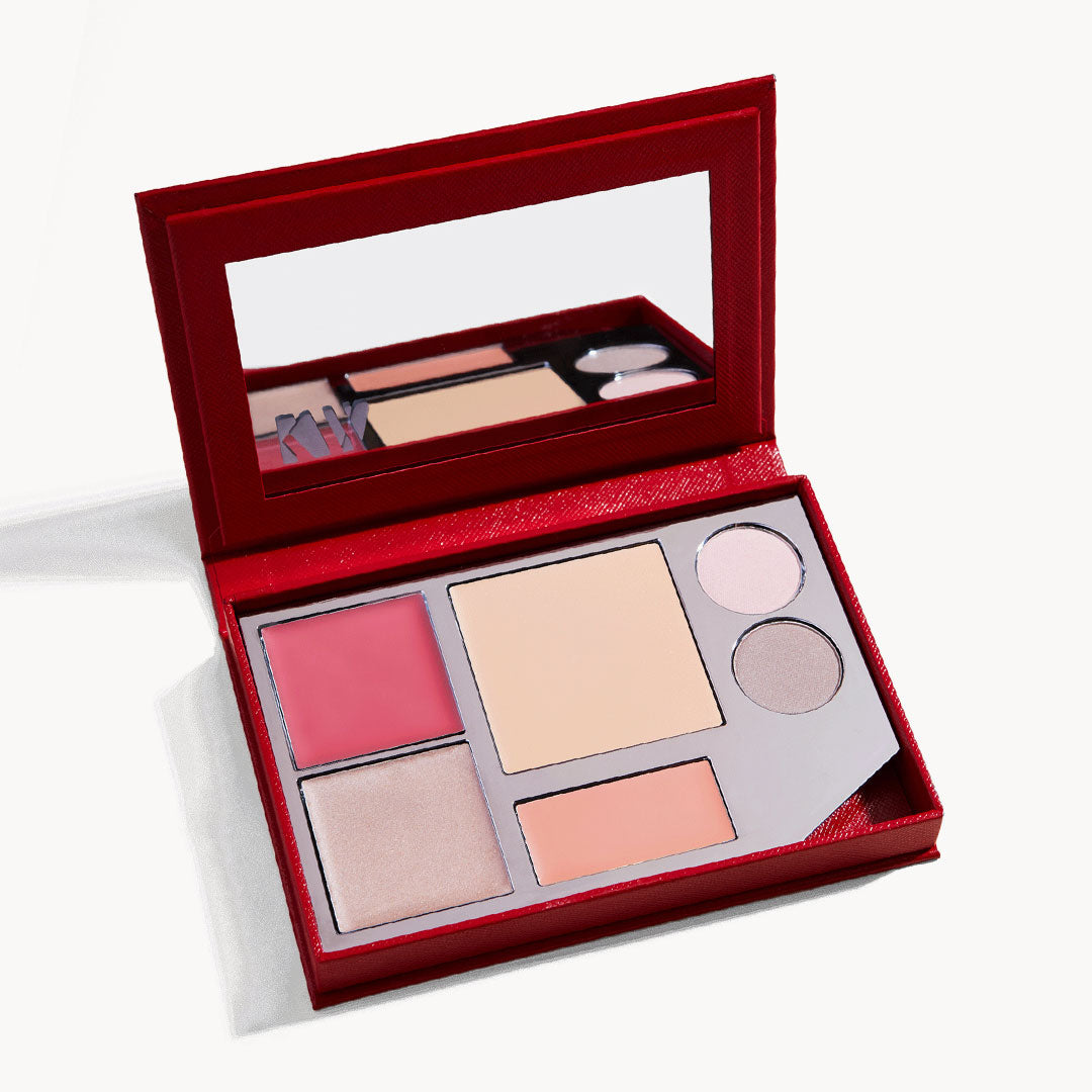 An open kit, showing the palette of cream blush, cream foundation, cream glow, lip tint, and two eye shadows, with a mirror on the inside of the lid