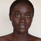 Photo of a person’s face with deep, neutral-toned skin